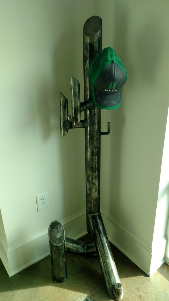 Unique and abstract steel free standing coat rack made from 4" pipe sections