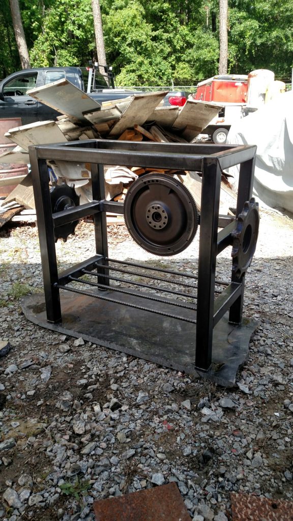 industrial furniture piece with discarded automotive and industrial parts made from tube steel