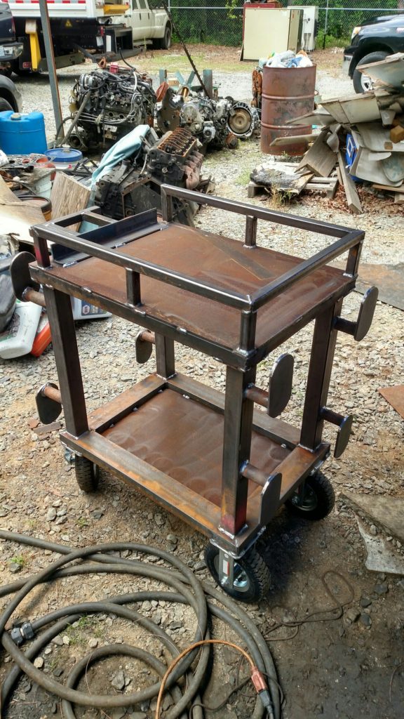 steel tool cart on casters with areas for holding drop cords, air hoses or power cords